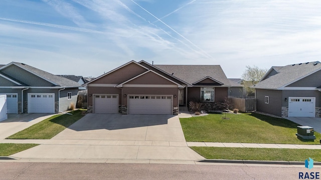 5508 S Sirocco Ave, Sioux Falls, SD 57108 - craftsman-style home featuring a front lawn, driveway, stone siding, and a garage