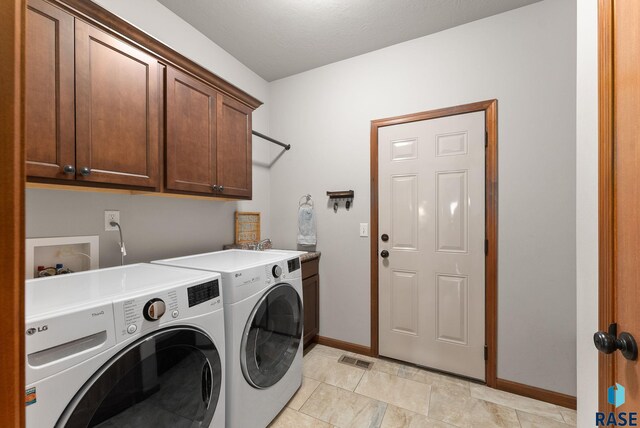 5508 S Sirocco Ave, Sioux Falls, SD 57108 - washroom with washer and dryer, baseboards, cabinet space, and visible vents