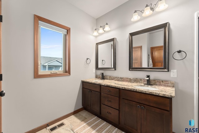 5508 S Sirocco Ave, Sioux Falls, SD 57108 - full bath with baseboards, a sink, visible vents, and double vanity