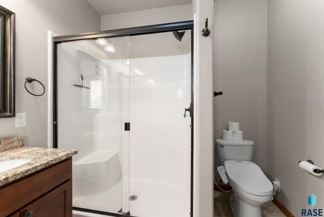5508 S Sirocco Ave, Sioux Falls, SD 57108 - bathroom featuring vanity, toilet, and a stall shower