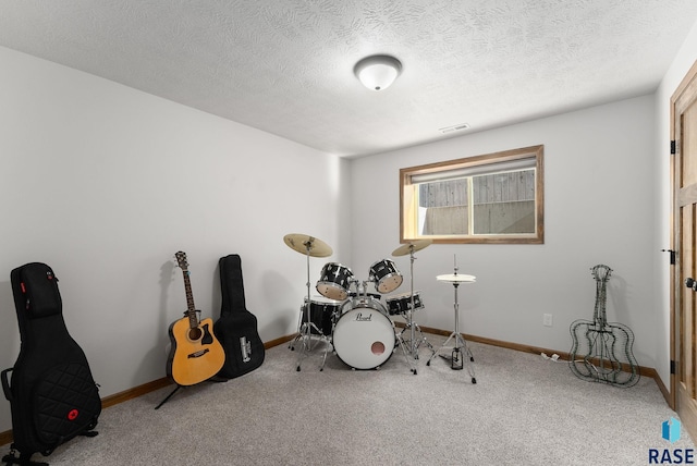 5508 S Sirocco Ave, Sioux Falls, SD 57108 - rec room with a textured ceiling, visible vents, carpet flooring, and baseboards