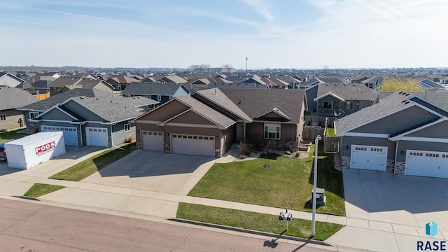 5508 S Sirocco Ave, Sioux Falls, SD 57108 - craftsman house with a front lawn, a residential view, driveway, stone siding, and a garage