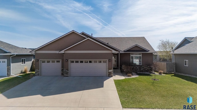 5508 S Sirocco Ave, Sioux Falls, SD 57108 - view of front facade featuring fence, a front lawn, an attached garage, driveway, and stone siding