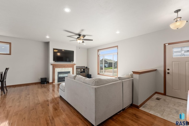 5508 S Sirocco Ave, Sioux Falls, SD 57108 - living room featuring light wood-style flooring, baseboards, recessed lighting, ceiling fan, and a tile fireplace