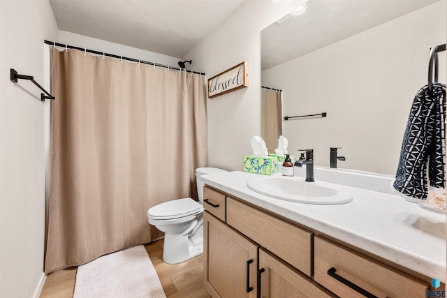 812 Sarah C Cir, Garretson, SD 57030 - bathroom featuring toilet, vanity, and wood finished floors
