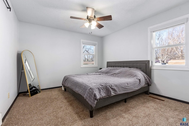 bedroom with carpet floors, a ceiling fan, and baseboards