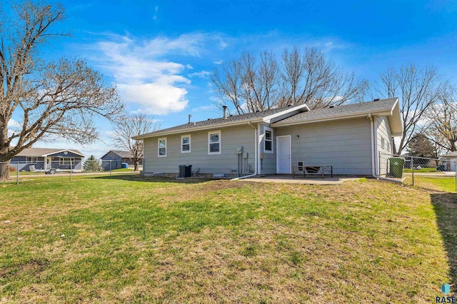 rear view of property with fence, a lawn, a patio area, and central air condition unit
