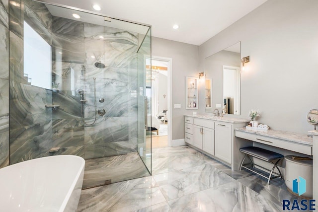 full bath featuring recessed lighting, marble finish floor, a shower with door, a freestanding bath, and vanity