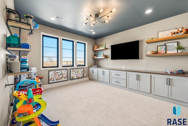 game room featuring baseboards, visible vents, carpet, and a notable chandelier