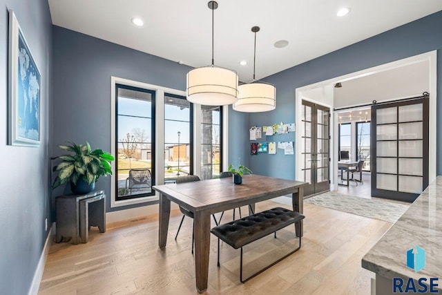 dining area featuring baseboards, french doors, light wood finished floors, and recessed lighting