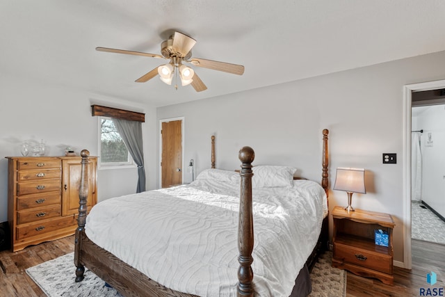 bedroom with baseboards, wood finished floors, and ceiling fan