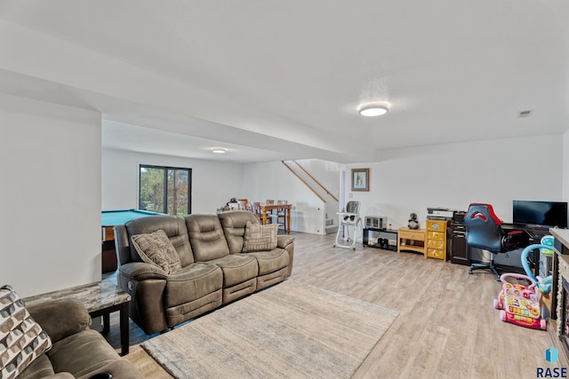 living area featuring billiards, wood finished floors, and stairway