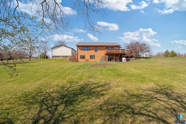 back of house with a wooden deck and a lawn