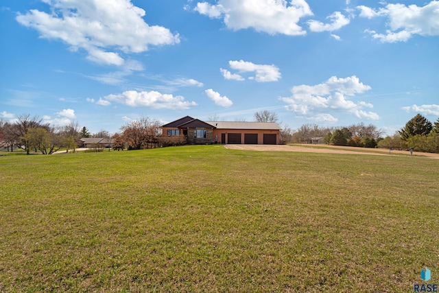 view of front of house with a garage, driveway, and a front yard