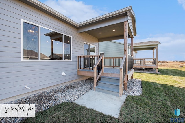 wooden deck featuring a lawn