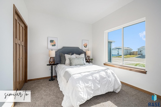 carpeted bedroom featuring baseboards