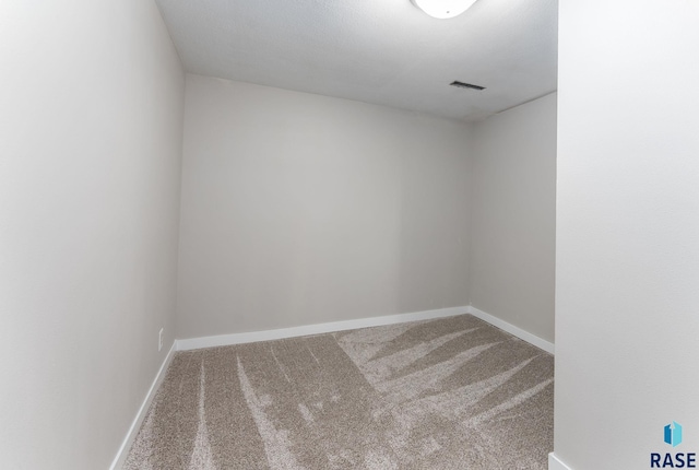 carpeted empty room with baseboards and visible vents