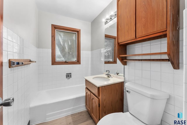 bathroom featuring tile walls, toilet, and wood finished floors