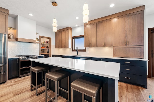 kitchen with stainless steel appliances, a kitchen breakfast bar, a sink, open shelves, and light countertops