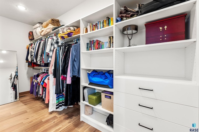 walk in closet with light wood-type flooring