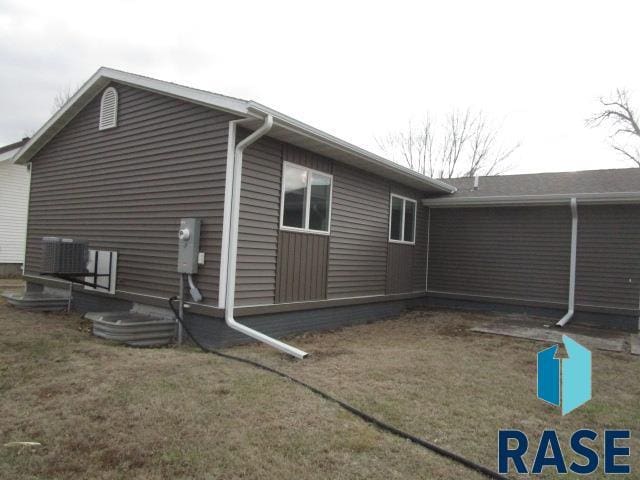 rear view of property with central AC unit