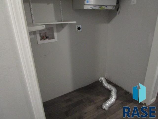 clothes washing area featuring wood finished floors, laundry area, and washer hookup