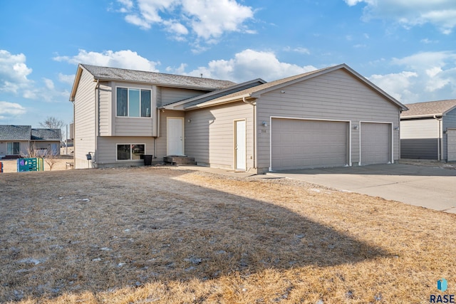 tri-level home featuring an attached garage and driveway