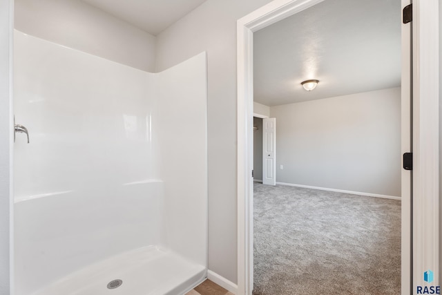 full bathroom featuring baseboards and a stall shower