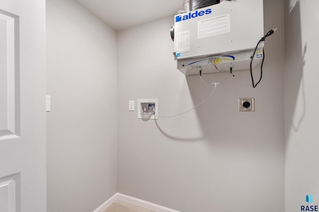 washroom with water heater, baseboards, hookup for an electric dryer, and hookup for a washing machine