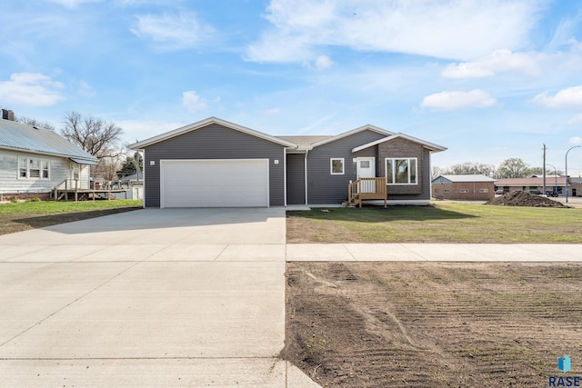 single story home with a garage, driveway, and a front yard
