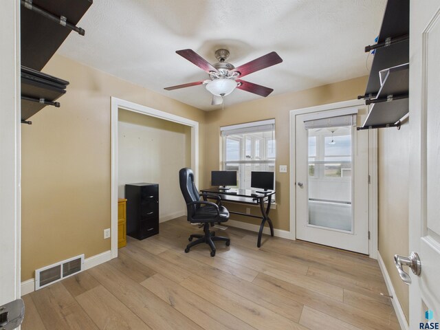 office area with visible vents, ceiling fan, baseboards, and light wood-style floors
