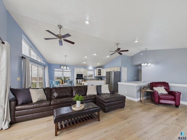 living room featuring ceiling fan, baseboards, vaulted ceiling, and light wood-style floors
