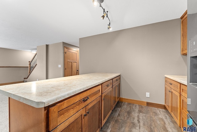 501 Taylor Dr, Tea, SD 57064 - kitchen with baseboards, a peninsula, brown cabinetry, and light countertops