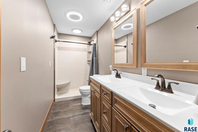 501 Taylor Dr, Tea, SD 57064 - full bathroom featuring toilet, a sink, tiled shower, and wood finished floors