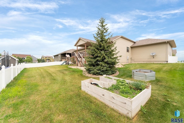 501 Taylor Dr, Tea, SD 57064 - view of yard with a vegetable garden, a wooden deck, stairs, and fence