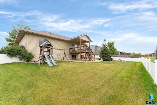 501 Taylor Dr, Tea, SD 57064 - back of house with a deck, a fenced backyard, stairs, a playground, and a lawn