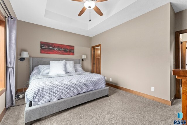 501 Taylor Dr, Tea, SD 57064 - carpeted bedroom featuring baseboards, a raised ceiling, and ceiling fan