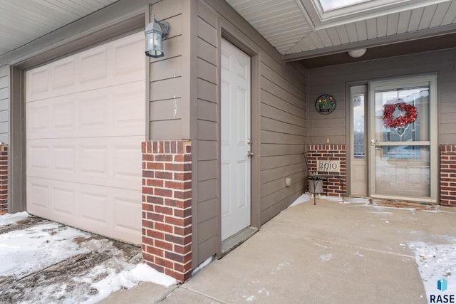 2010 S Barret Pl, Sioux Falls, SD 57106 - doorway to property featuring an attached garage and brick siding