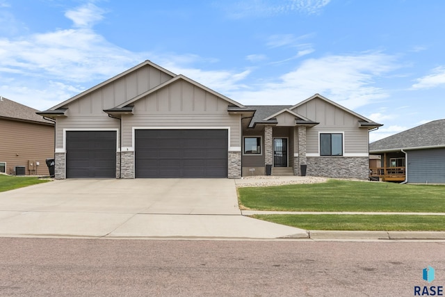 1917 S Firefly Dr, Sioux Falls, SD 57110 - craftsman inspired home with a front yard, driveway, stone siding, board and batten siding, and an attached garage