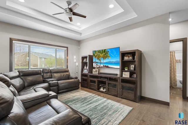 1917 S Firefly Dr, Sioux Falls, SD 57110 - living room with wood finished floors, ceiling fan, a raised ceiling, and recessed lighting