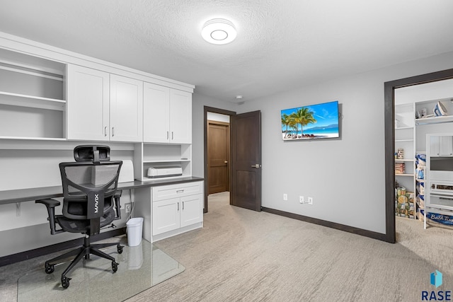 1917 S Firefly Dr, Sioux Falls, SD 57110 - office area featuring light colored carpet, a textured ceiling, and baseboards