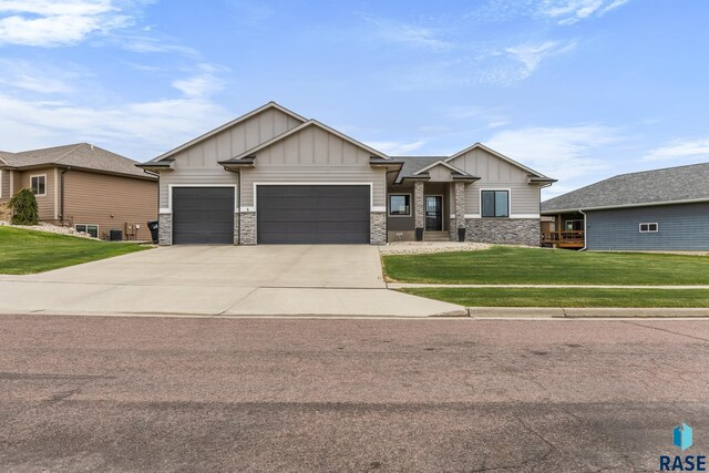 1917 S Firefly Dr, Sioux Falls, SD 57110 - craftsman inspired home with a front yard, stone siding, board and batten siding, concrete driveway, and an attached garage