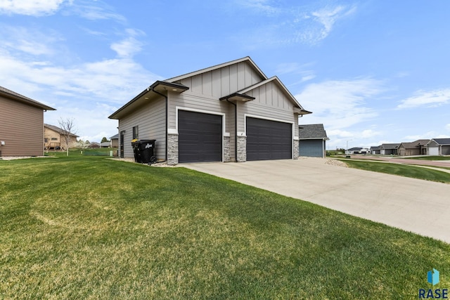 1917 S Firefly Dr, Sioux Falls, SD 57110 - view of side of property featuring board and batten siding, a residential view, driveway, stone siding, and a lawn