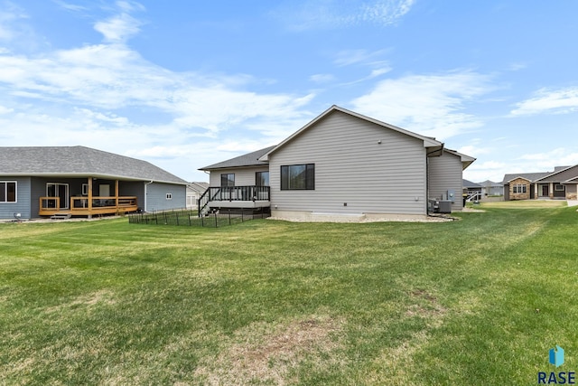 1917 S Firefly Dr, Sioux Falls, SD 57110 - rear view of property with cooling unit, a wooden deck, and a yard