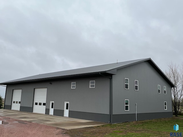view of side of home with an outdoor structure and a garage