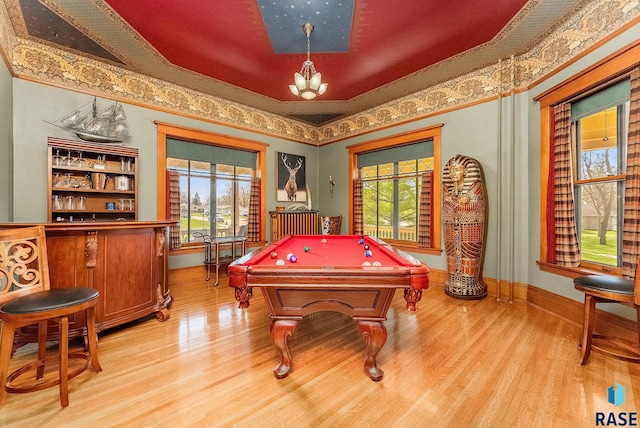 rec room featuring a chandelier, billiards, light wood finished floors, and plenty of natural light
