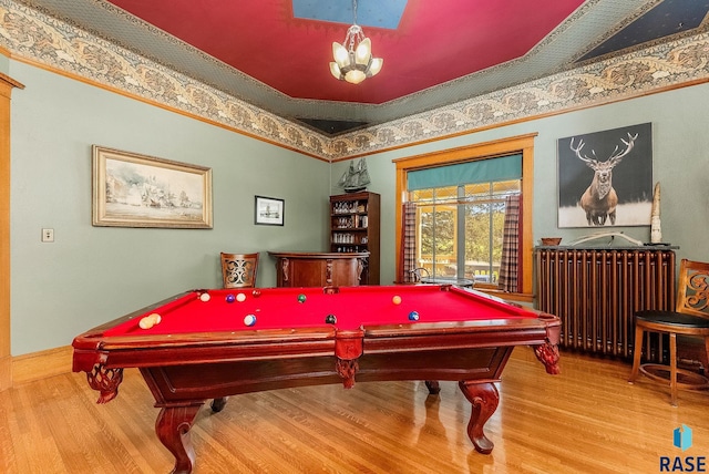 rec room featuring radiator, billiards, a chandelier, and wood finished floors