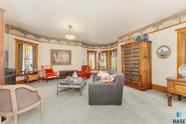 carpeted living area with baseboards and radiator