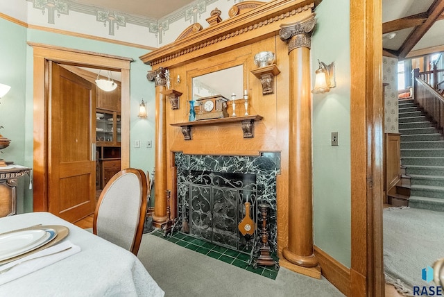 interior space with ornamental molding, a premium fireplace, and carpet