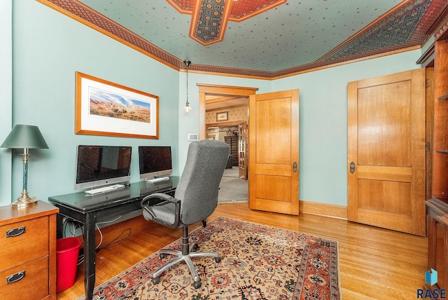 home office featuring baseboards and light wood-type flooring